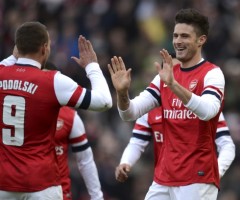 Arsenal's Giroud celebrates with teammate Podolski after Giroud scored a goal during their FA Cup fourth round soccer match against Brighton and Hove Albion in Brighton