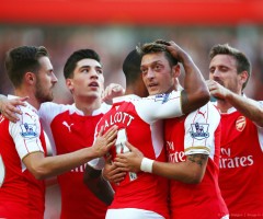 Arsenal players celebrate the opening goal