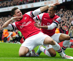 Arsenal's French striker Olivier Giroud (L) celebrates scoring their third with English striker Theo Walcott (R) goal during the English Premier League football match between Arsenal and Tottenham Hotspur at The Emirates Stadium in north London, England on November 17, 2012. AFP PHOTO/GLYN KIRK

RESTRICTED TO EDITORIAL USE. No use with unauthorized audio, video, data, fixture lists, club/league logos or ?live? services. Online in-match use limited to 45 images, no video emulation. No use in betting, games or single club/league/player publications.        (Photo credit should read GLYN KIRK/AFP/Getty Images)