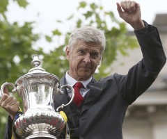 The Arsenal manager Arsene Wenger holds the FA Cup during Sunday's victory parade in north London.